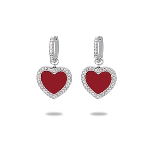 Detailed view of silver heart earrings with red inlay and crystal setting on white background