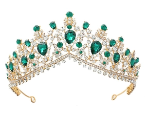 Close-up of golden bridal crown featuring teardrop green gemstones and sparkling crystals