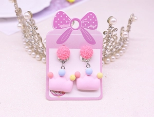 Detailed view of pink crown clip-on earrings with colorful beads for children