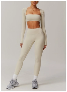Detailed close-up of cream white three-piece yoga set with brushed elastic fabric texture