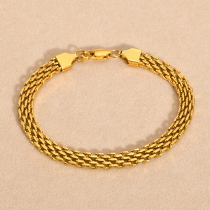 Detail of 18K gold mesh chain bracelet with a secure lobster clasp and polished finish