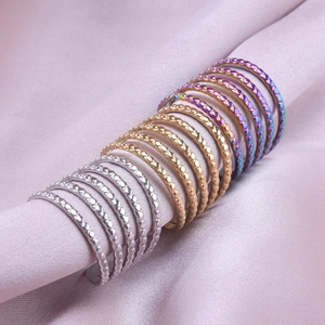 Macro detail of 304 stainless steel beaded open rings in gold, silver and rainbow colors