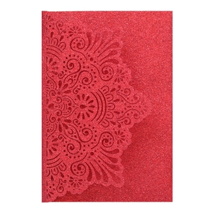 Detail of red glitter cardstock with intricate laser-cut hollow mandala floral pattern