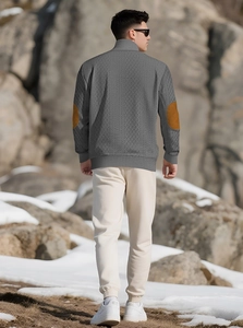 Detail view of men's grey knit jacket featuring stylish brown suede elbow patches on sleeves