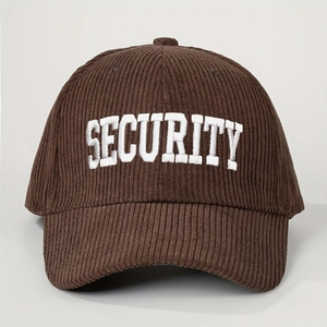 Macro detail of white SECURITY embroidery on brown corduroy texture of the baseball cap