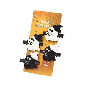 Set of four Halloween ghost hair clips with glitter details on a decorative display card