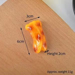 Macro shot of realistic roasted chicken wing model on wooden background with 6cm size label