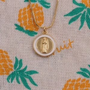 Detail of gold-plated portrait pendant with white enamel border and Virgin Mary relief