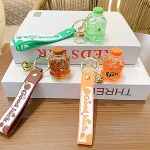 Creative soda bottle keychain set with colorful silicone straps and small bells