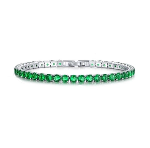 Detail of silver tennis bracelet with round-cut emerald green stones in claw setting