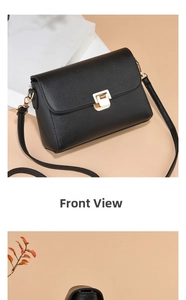 Detailed close-up of a black textured PU leather crossbody bag with a golden square lock