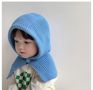 Close-up of light blue knit baby hood scarf with matching buttons and warm texture