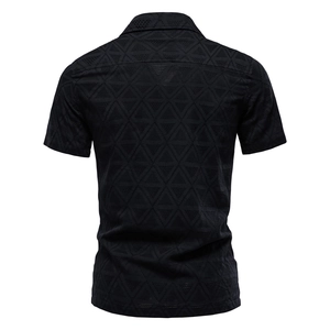 Detail of black short-sleeve shirt back view showing fine jacquard texture and woven pattern