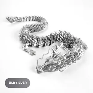 Macro detail of silk silver 3D printed dragon showing flexible joints and metallic scales