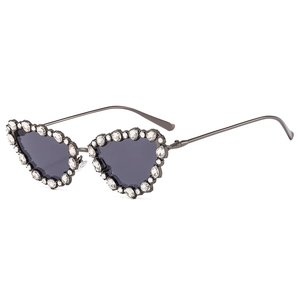 Luxe cat-eye sunglasses with rhinestone-encrusted metal frames and dark lenses