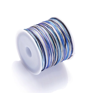 Close-up of multicolor gradient 72# jade thread wound on a white plastic spool for DIY