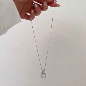 Macro view of silver S925 necklace featuring a translucent round stone and zircon inlay