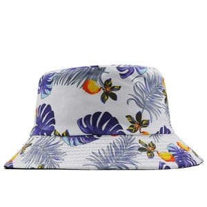 Detail of double-sided tropical leaf print on reversible bucket hat with floral patterns