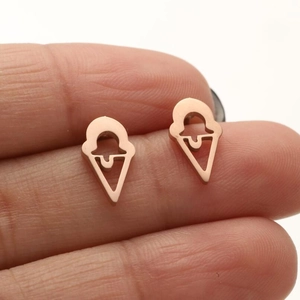 Detail of rose gold ice cream cone earrings with hollow design on skin for scale