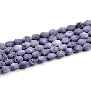 Macro shot of purple oval geode agate beads showing natural lava textures for DIY jewelry