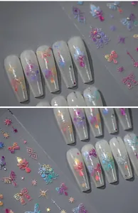 Detail of 3D embossed nail stickers featuring holographic bows and starry patterns