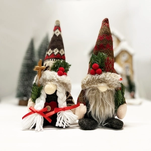 Close-up of Christmas gnomes with knitted hats and faux fur beards in festive setting