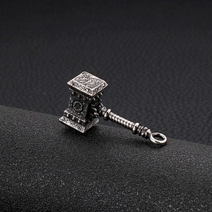 Macro shot of retro silver Mjolnir pendant with relief patterns on black leather