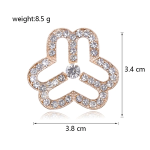 Detailed view of women's floral brooch with sparkling rhinestones and size measurements