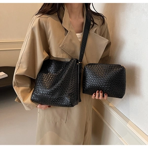 Detail of black woven texture on bucket bag set including large tote and matching pouch