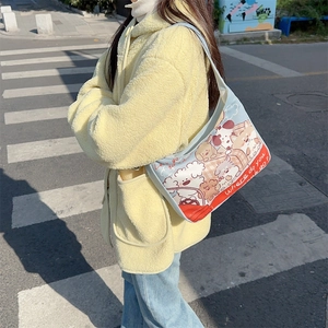 Outdoor shot of a cartoon bear canvas tote bag with stylish blue and red graphics