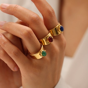 Gold plated wide band rings set with oval green red and blue natural stones
