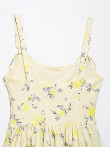 Detail of floral poplin mini dress featuring yellow flower prints and side zipper closure