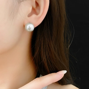 Detailed macro view of a large 12mm white pearl ear cuff earring on a black background
