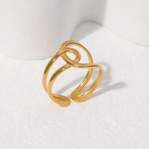 Detailed close-up of a double-layered golden stainless steel ring with a geometric twist