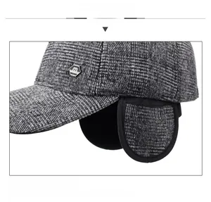 Detail view of winter baseball cap featuring plaid fabric and warm ear flaps for men