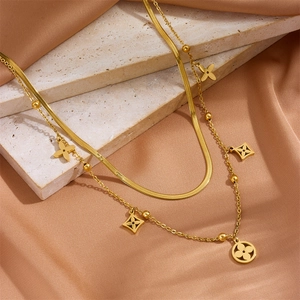 Double-layered gold titanium necklace with clover pendants on silk and stone base