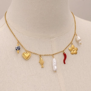 Gold pendant necklace with blue ceramic beads and pearls on beige mannequin bust