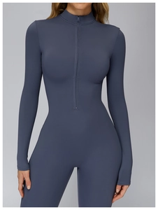 Detail of slate blue yoga jumpsuit with high collar zipper and slim fit athletic design