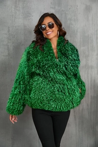 Close-up of bright green faux fox fur texture and fluffy long fibers on fashion coat
