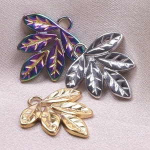 Detailed view of three leaf pendants in rainbow, silver and gold finish for DIY necklaces
