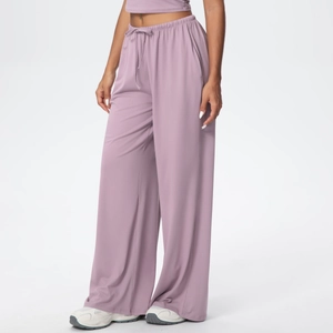 Detail of high-waisted lavender wide-leg yoga pants with adjustable drawstring and pockets