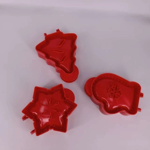 Three-piece red plastic Christmas cookie cutter set featuring tree, snowflake, and glove shapes