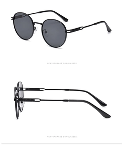 Detail view showing black metal round frames and dark lenses of retro sunglasses