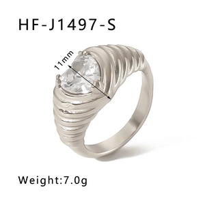 Macro shot of silver stainless steel ring with 11mm heart-shaped zircon and ribbed texture