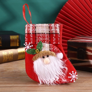 Close-up of red felt Christmas stocking with 3D Santa Claus and red plaid cuff detail