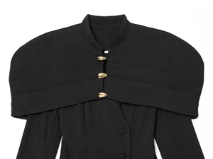 Detailed view of black tailored blazer with gold teardrop buttons and layered lapel
