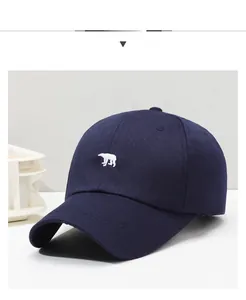 Detailed view of the navy blue cotton twill baseball cap with white bear embroidery