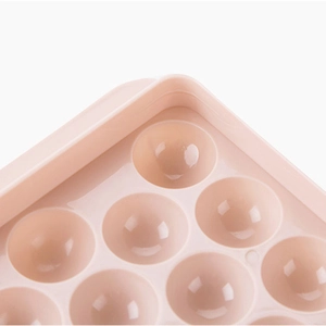 Pink spherical ice cube mold with 33 compartments made of durable plastic material