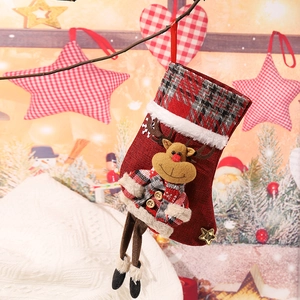 Close-up of a Christmas stocking with 3D reindeer doll hanging on a festive tree