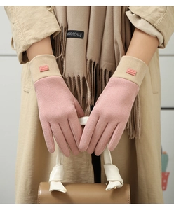 Detailed shot of pink and beige suede gloves with 'FASHION GLOVES' tags on wrist